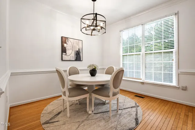 a view of a dining room with furniture wooden floor and a chandelier