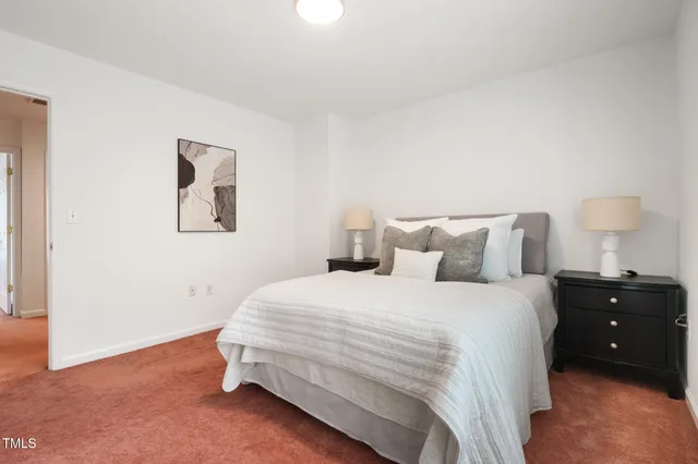 a bedroom with a bed and a night stand