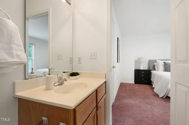 a en suite bathroom with a sink and a mirror