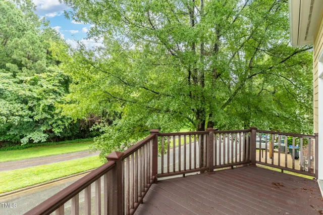 a view of a balcony with wooden floor