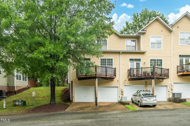 a car parked in front of a white house
