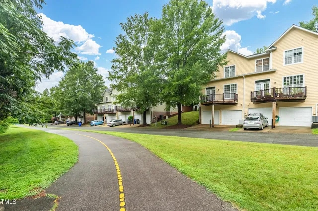 a view of a street with houses and trees