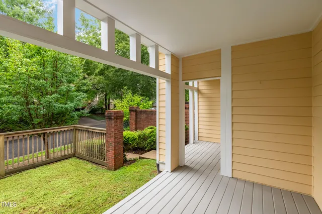 a view of a house with a small yard and wooden floor