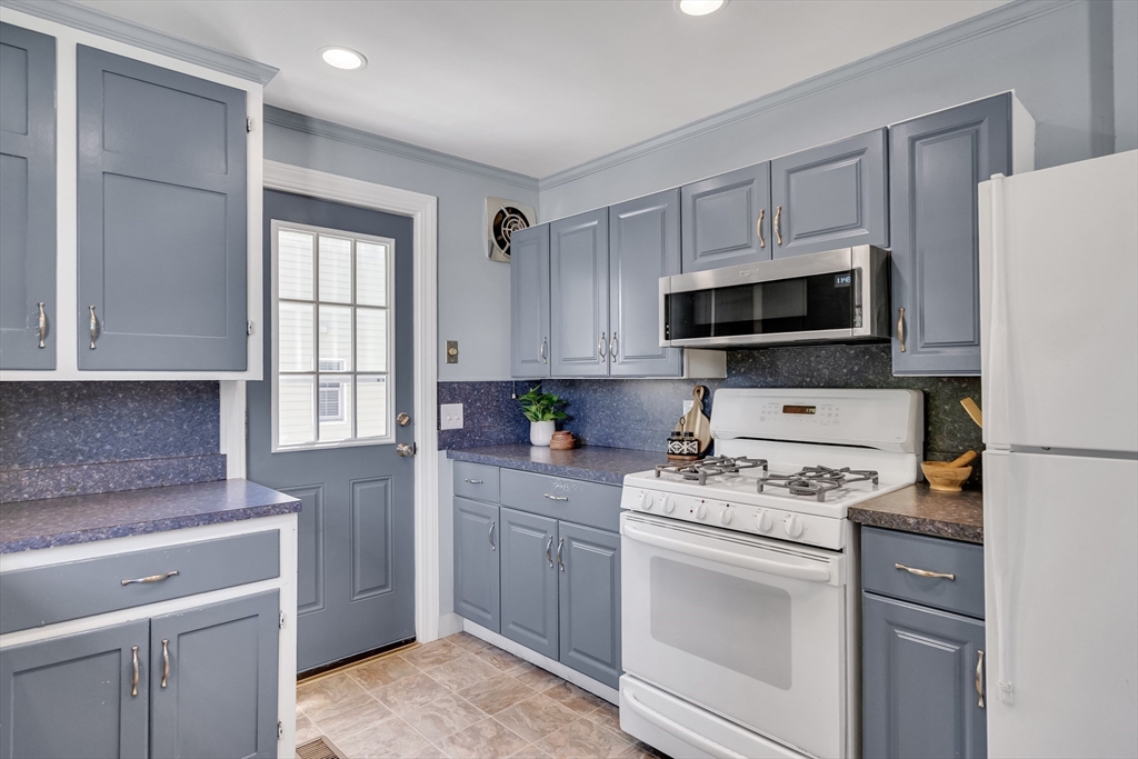 16 Roundwood Road Newton, MA 02464 - Photo 15 of 41 a kitchen with a stove a sink and a microwave