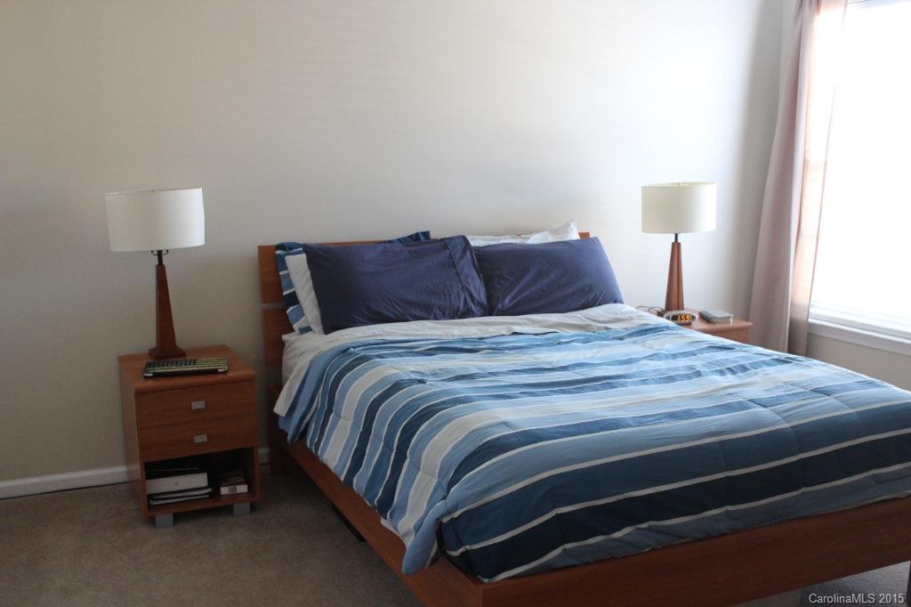 111 Hollyhurst Lane Fort Mill, SC 29708 - Photo 14 of 19 a large bed sitting in a bedroom next to a lamp