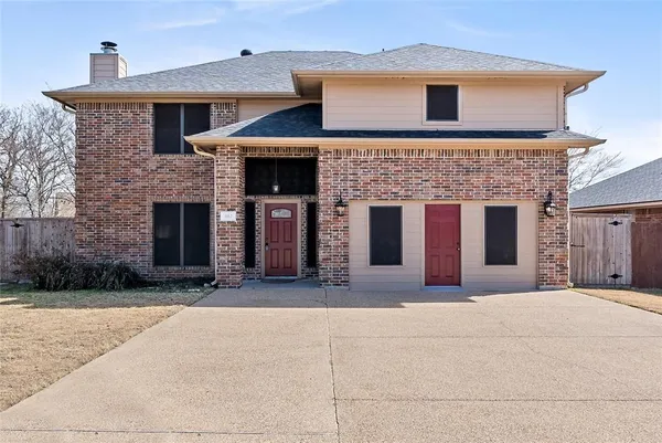 a front view of a house with yard and parking space