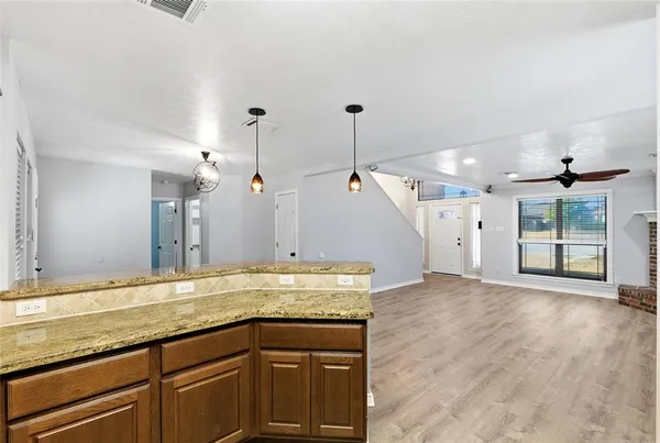 a view of a kitchen with a sink and wooden floor