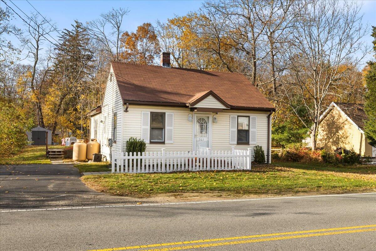 a front view of a house with a garden and plants