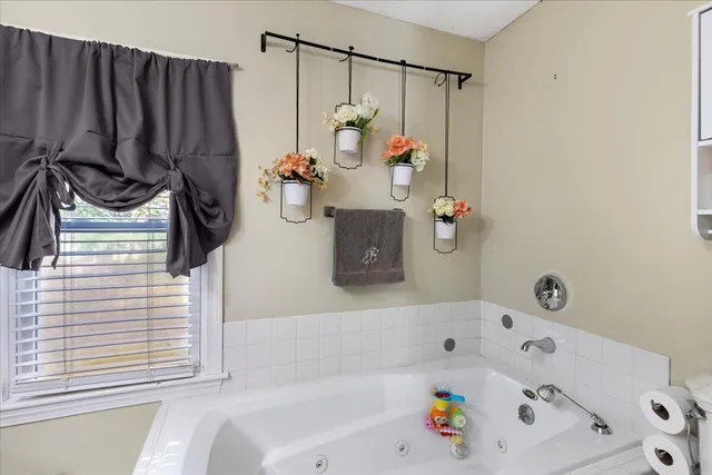 a bathroom with a bathtub and a window