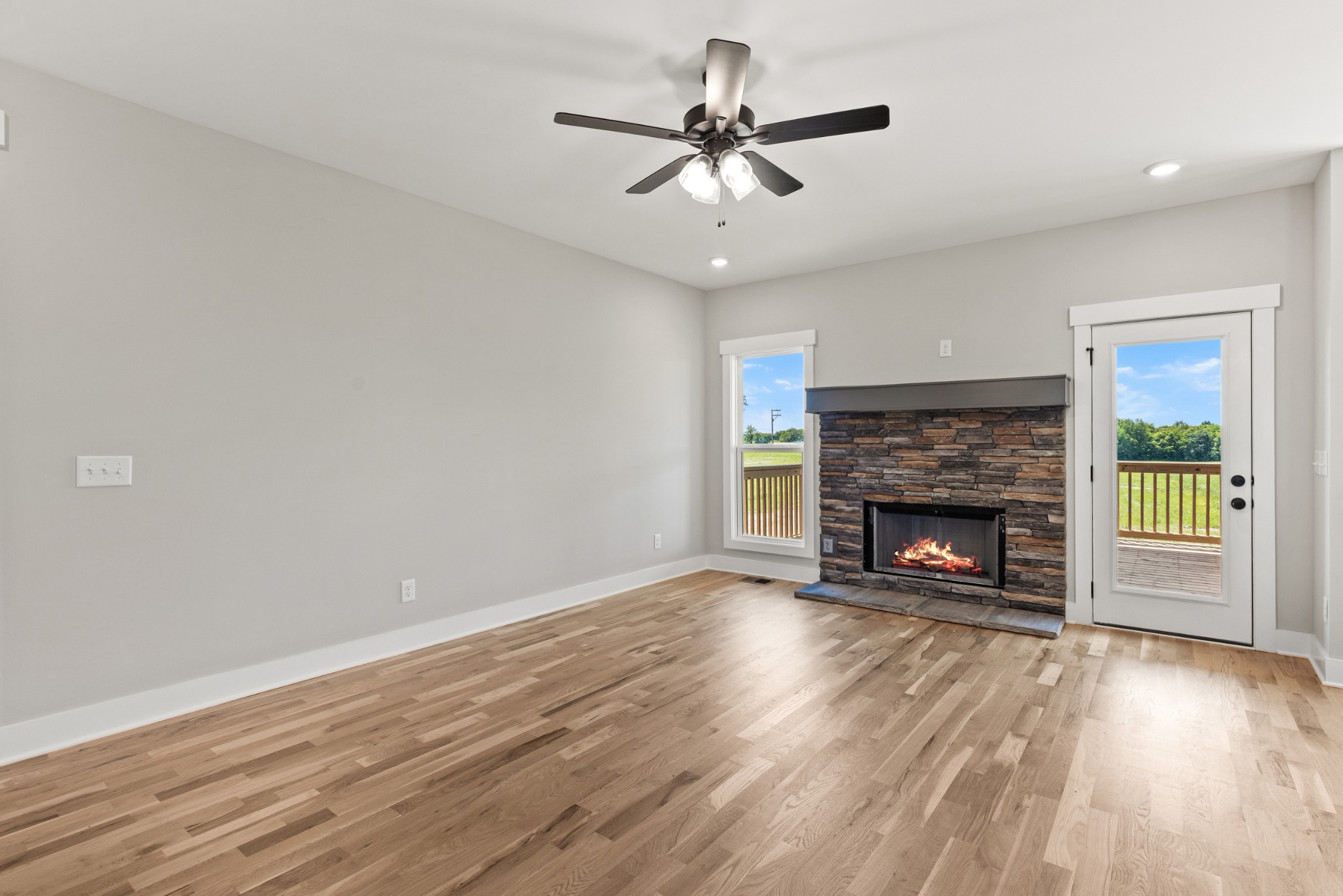 5638 Borthick Road Springfield, TN 37172 - Photo 8 of 43 a view of an empty room with wooden floor fireplace and a window