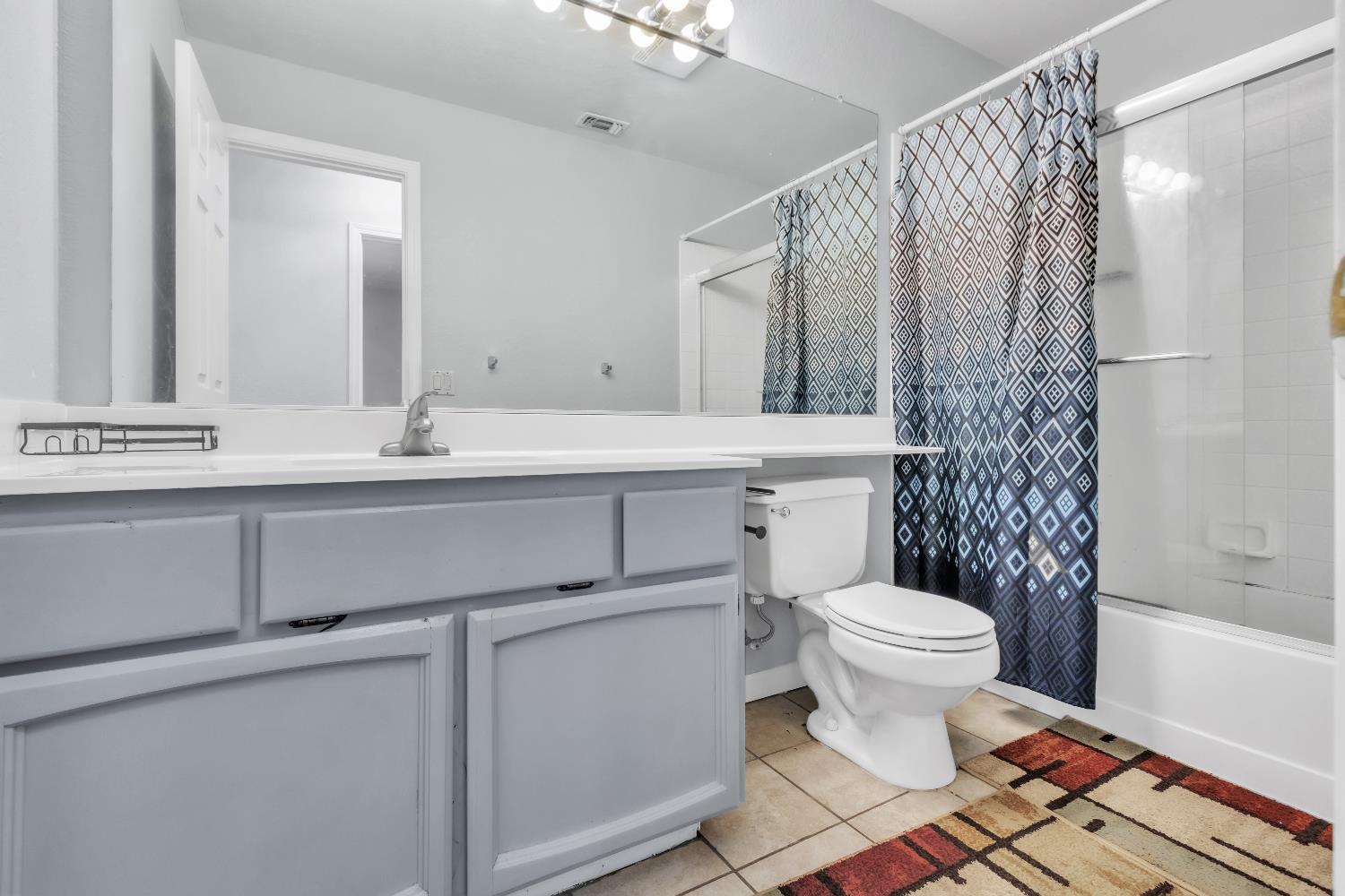 8148 Orchid Tree Way Antelope, CA 95843 - Photo 28 of 33 a bathroom with a sink toilet a mirror and shower