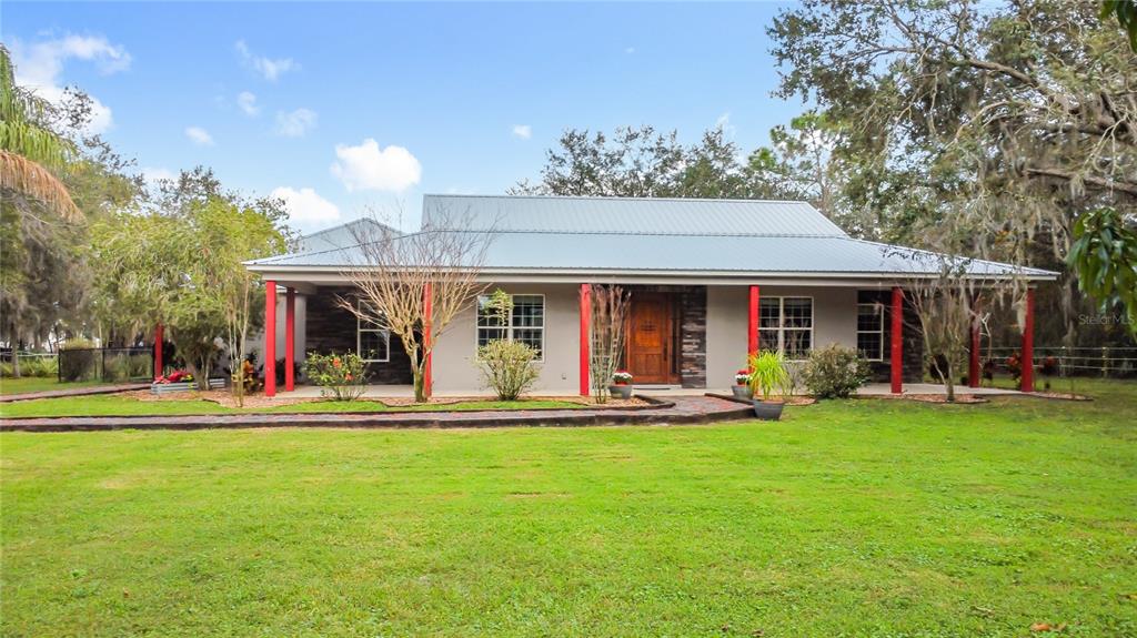 a front view of a house with a garden and patio