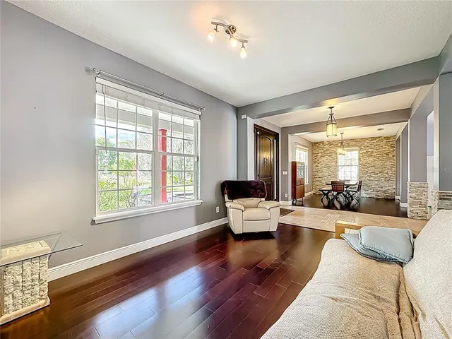 a living room with furniture and wooden floor
