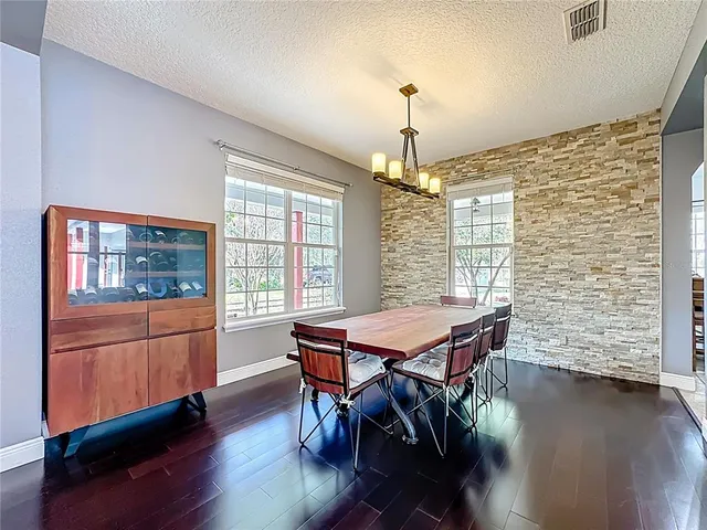 a room with pool table flat screen tv and window