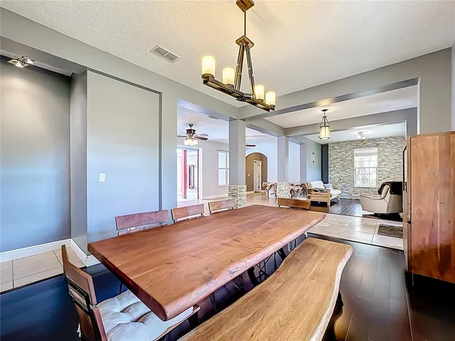 a view of a livingroom with furniture wooden floor and chandelier