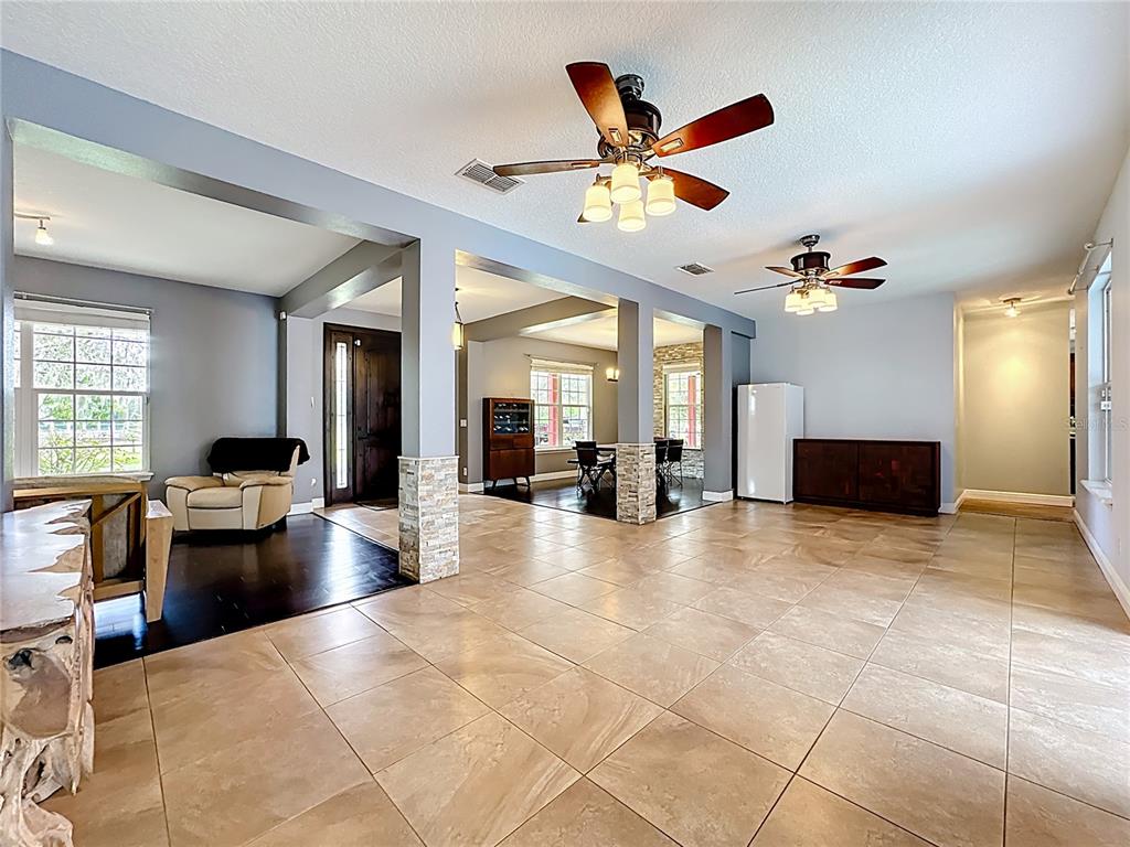 4295 Rambler Avenue St. Cloud, FL 34772 - Photo 15 of 54 a view of a livingroom with furniture wooden floor and chandelier