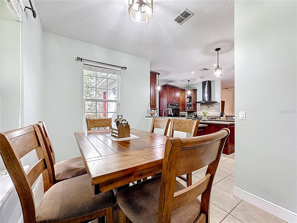 4295 Rambler Avenue St. Cloud, FL 34772 - Photo 17 of 54 a view of a dining room with furniture