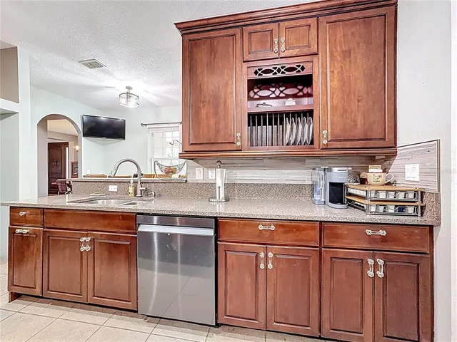 a kitchen with stainless steel appliances granite countertop a sink and stove