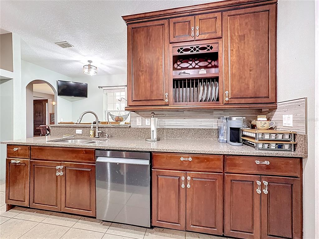 4295 Rambler Avenue St. Cloud, FL 34772 - Photo 19 of 54 a kitchen with white cabinets and a sink