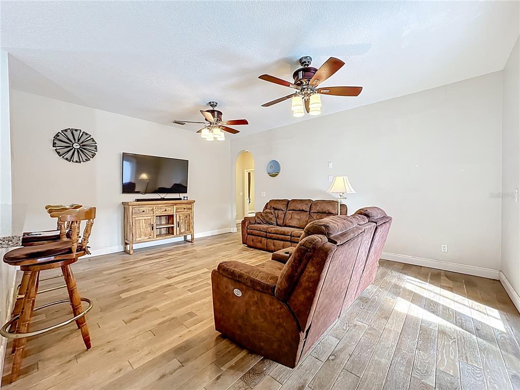 4295 Rambler Avenue St. Cloud, FL 34772 - Photo 22 of 54 a living room with furniture and a flat screen tv