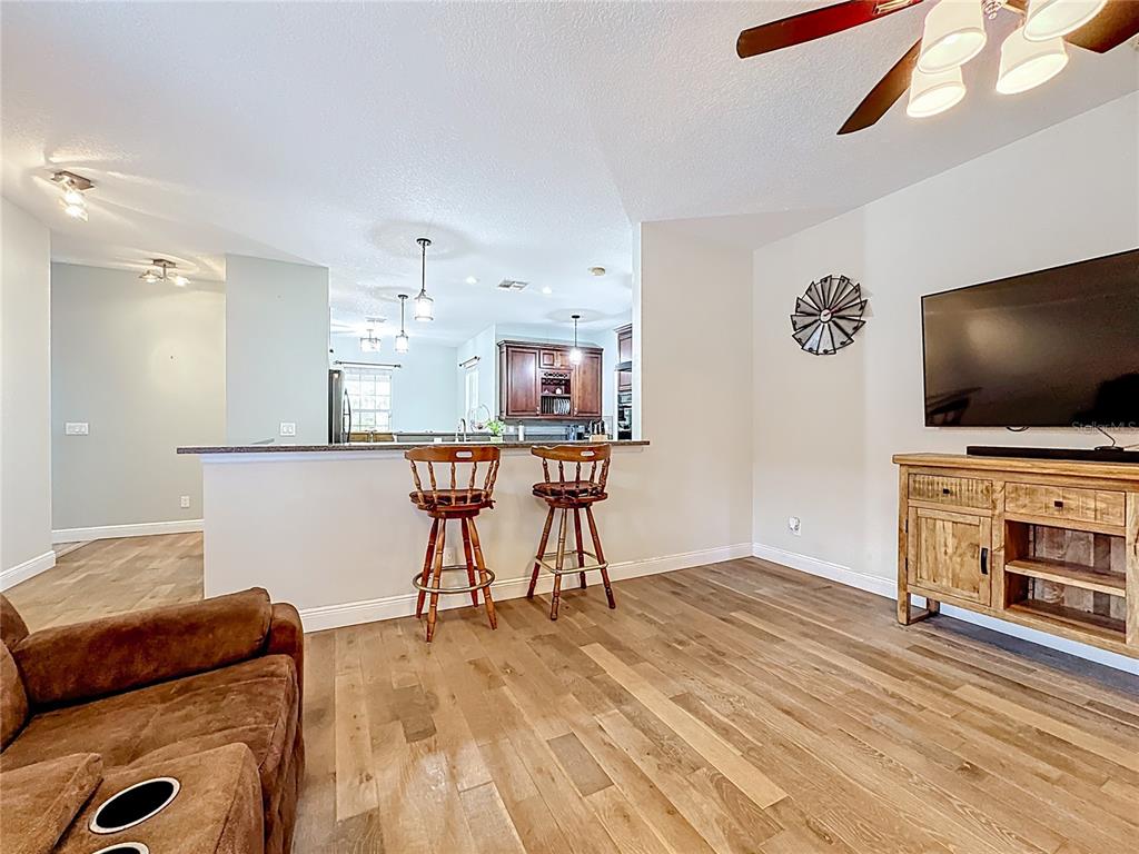 4295 Rambler Avenue St. Cloud, FL 34772 - Photo 25 of 54 a living room with furniture and a flat screen tv