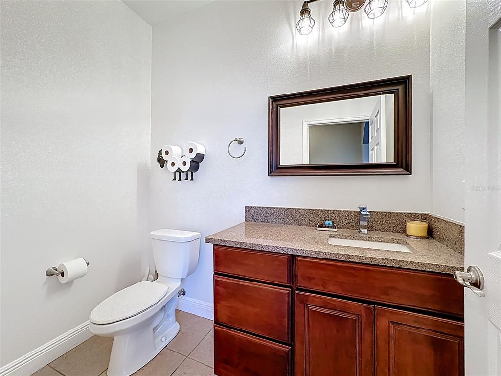 4295 Rambler Avenue St. Cloud, FL 34772 - Photo 27 of 54 a bathroom with a toilet sink and mirror
