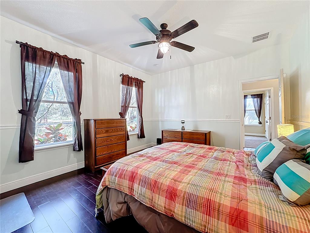 4295 Rambler Avenue St. Cloud, FL 34772 - Photo 28 of 54 a bedroom with a bed and wooden floor