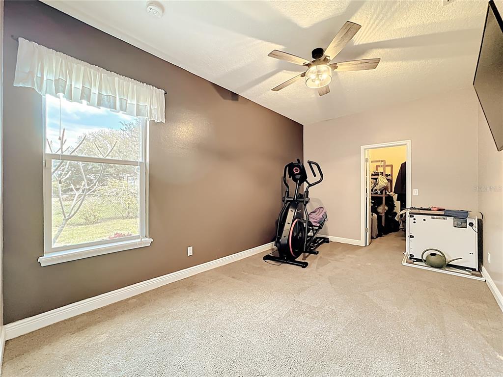 4295 Rambler Avenue St. Cloud, FL 34772 - Photo 30 of 54 a room with gym equipment and a window