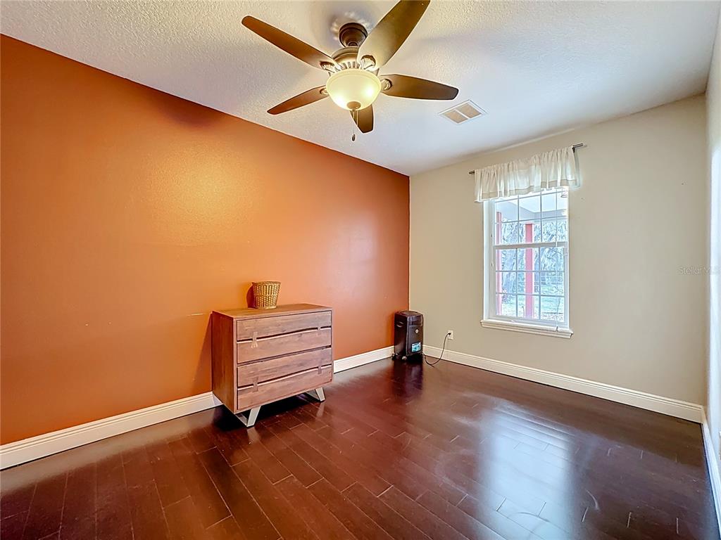4295 Rambler Avenue St. Cloud, FL 34772 - Photo 31 of 54 a view of an empty room with a window and wooden floor