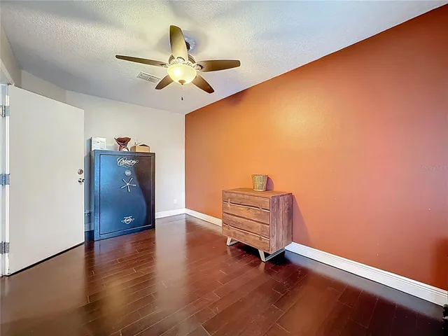 a bathroom with a toilet sink vanity and mirror