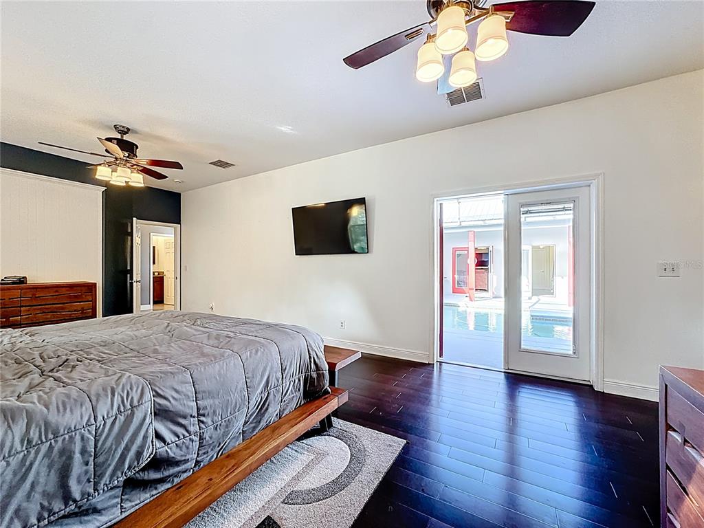 4295 Rambler Avenue St. Cloud, FL 34772 - Photo 36 of 54 a bedroom with a bed and wooden floor