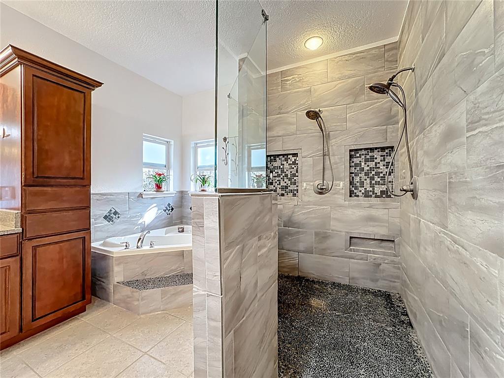 4295 Rambler Avenue St. Cloud, FL 34772 - Photo 38 of 54 a bathroom with a bathtub and a shower