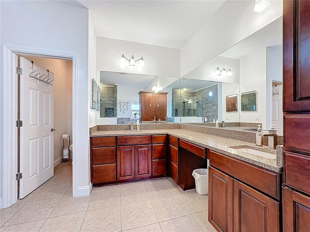 4295 Rambler Avenue St. Cloud, FL 34772 - Photo 39 of 54 a large kitchen with stainless steel appliances and cabinets