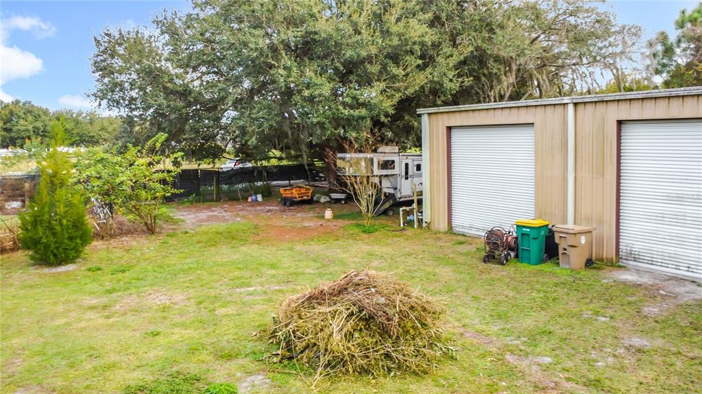 4295 Rambler Avenue St. Cloud, FL 34772 - Photo 49 of 54 a view of a patio with table and chairs and potted plants
