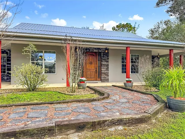a living room with a bed furniture and a chandelier