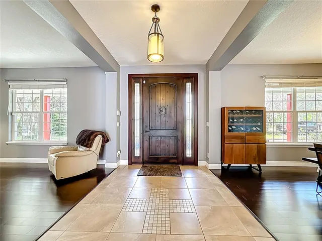 a living room with couches and painting on the wall with wooden floor