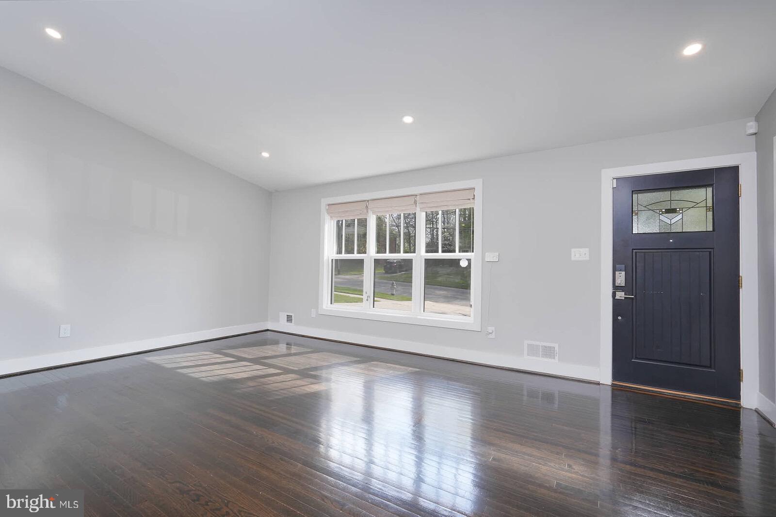 13304 Hathaway Drive Silver Spring, MD 20906 - Photo 26 of 59 a view of an empty room with wooden floor and a window