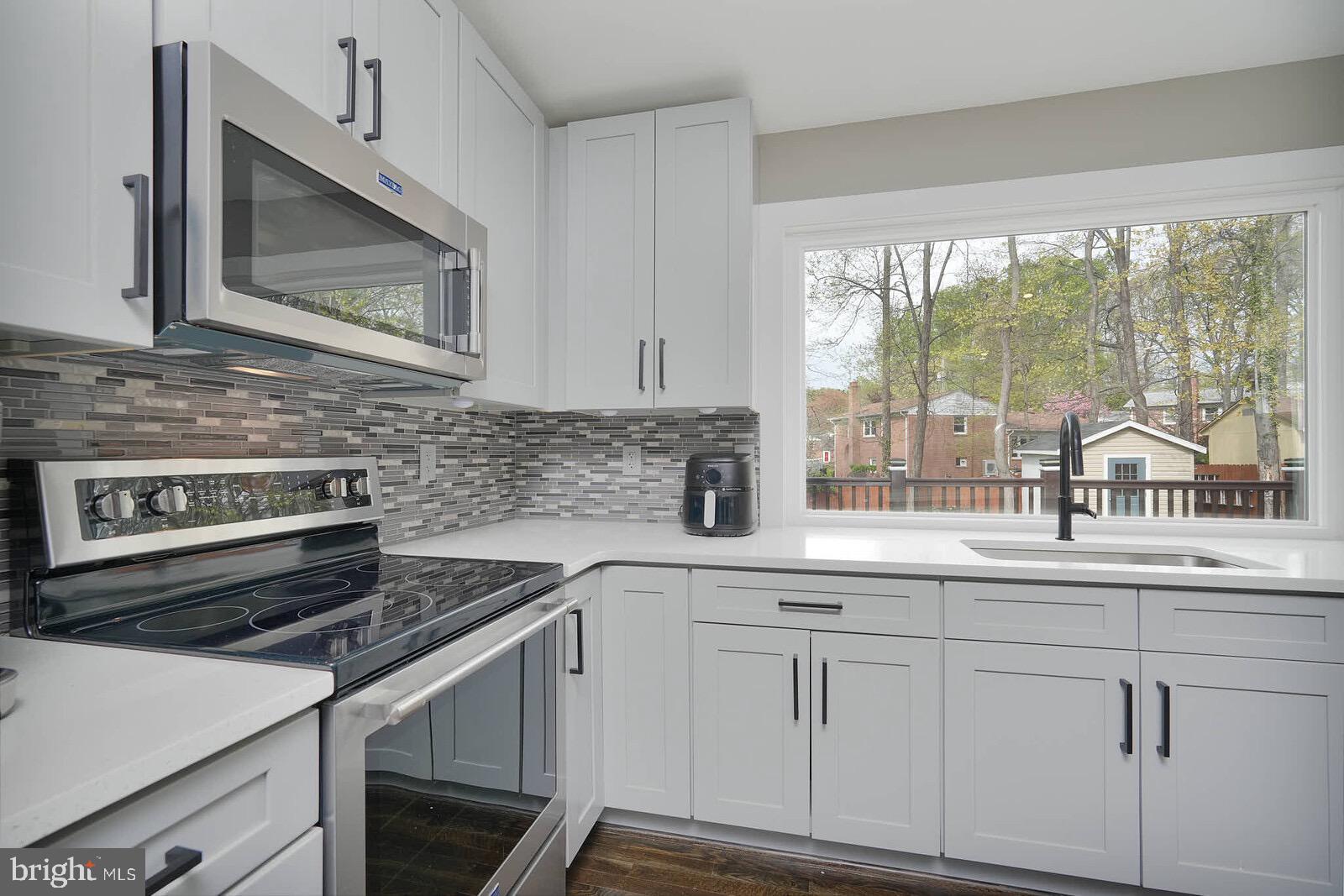 13304 Hathaway Drive Silver Spring, MD 20906 - Photo 38 of 59 a kitchen with white cabinets and appliances