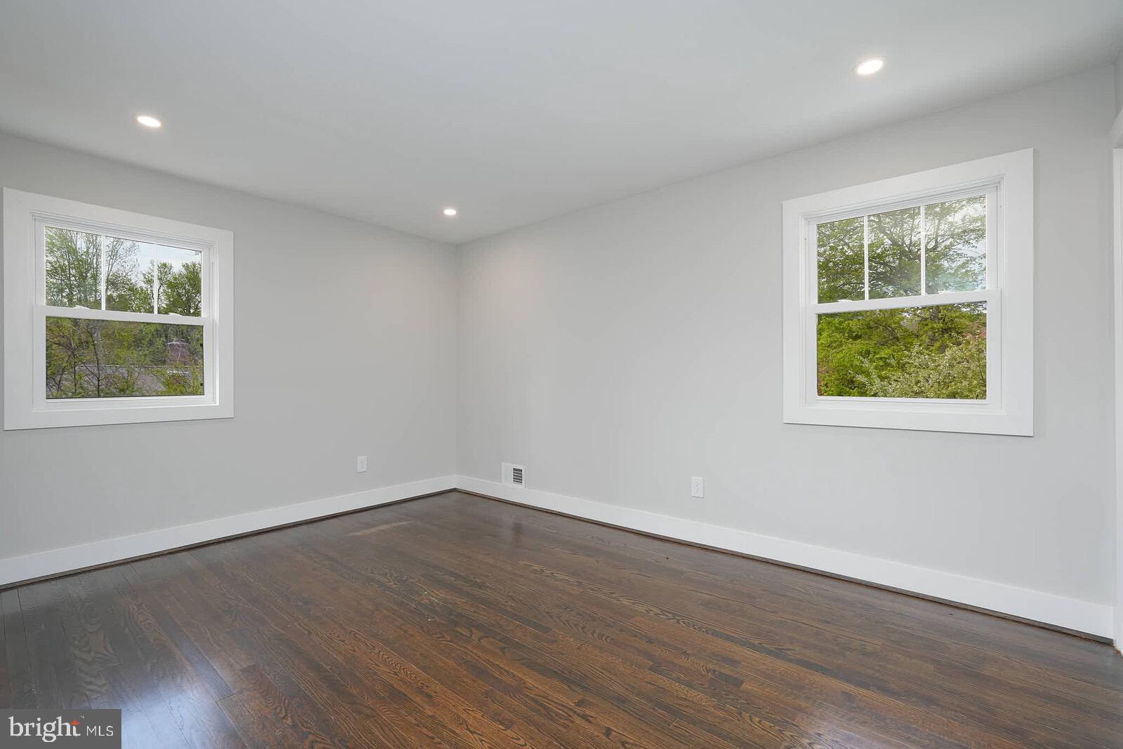 13304 Hathaway Drive Silver Spring, MD 20906 - Photo 40 of 59 a view of an empty room with wooden floor and a window