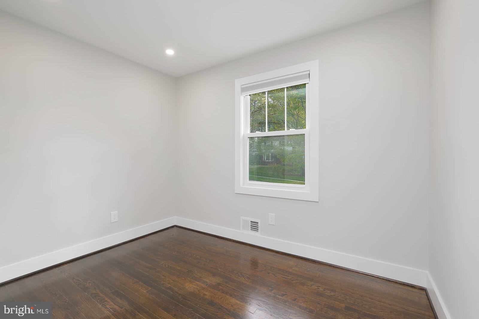 13304 Hathaway Drive Silver Spring, MD 20906 - Photo 48 of 59 an empty room with wooden floor and windows