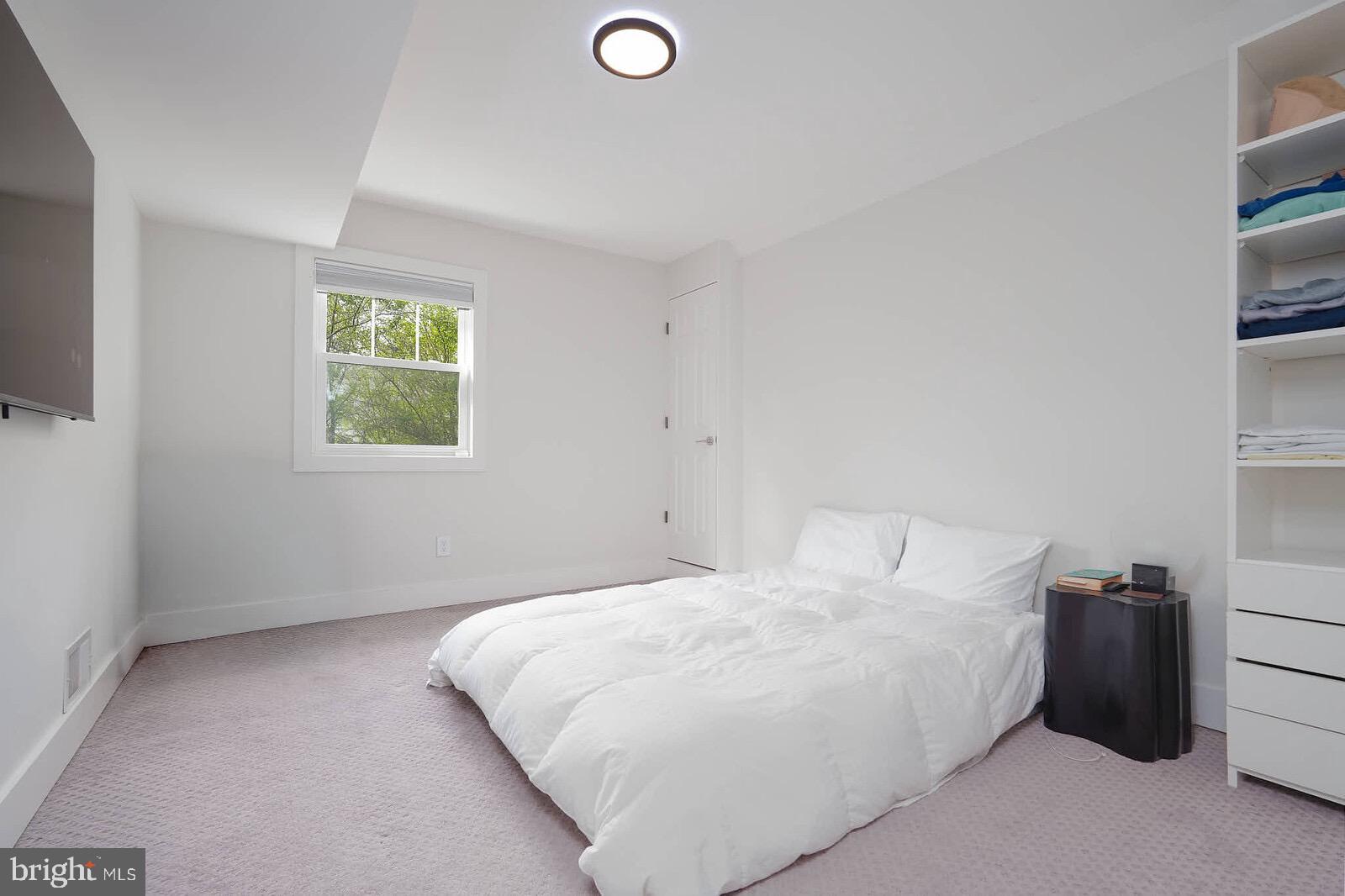 13304 Hathaway Drive Silver Spring, MD 20906 - Photo 55 of 59 a bedroom with a bed and a window