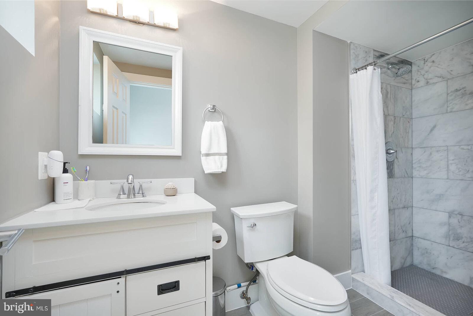 13304 Hathaway Drive Silver Spring, MD 20906 - Photo 56 of 59 a bathroom with a sink toilet vanity and shower