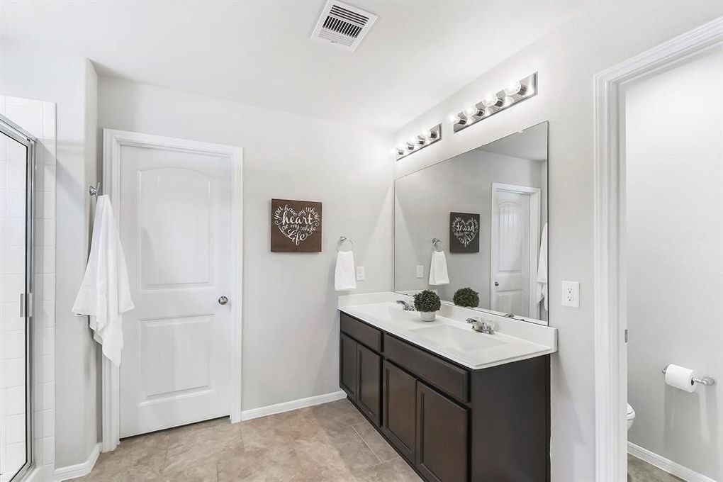 3010 Dripping Springs Court Katy, TX 77494 - Photo 14 of 22 a bathroom with a sink and a mirror
