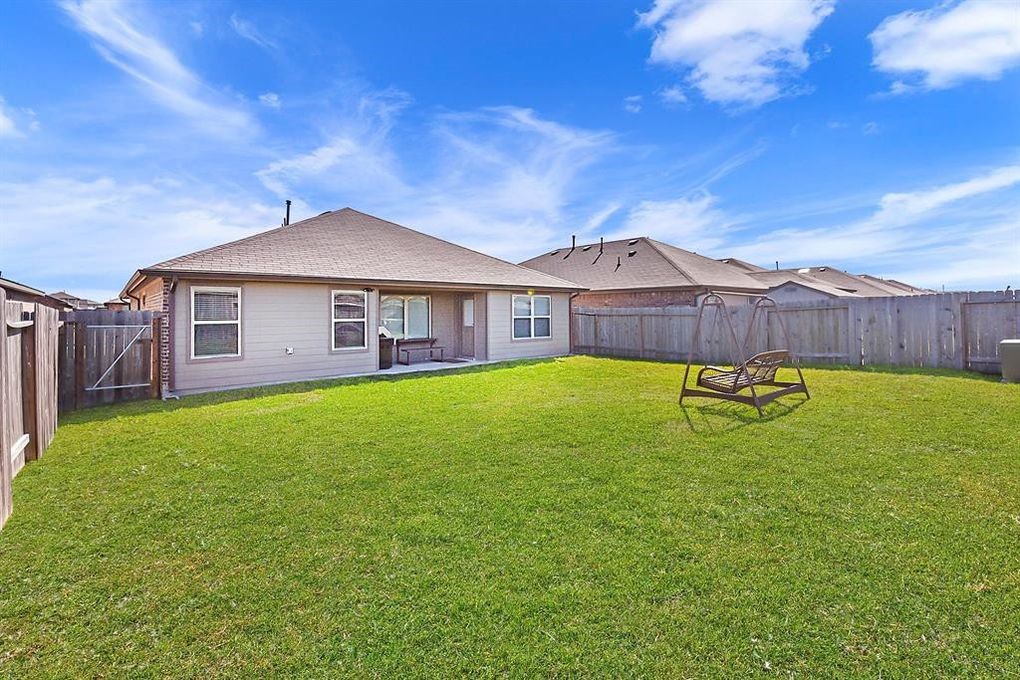 3010 Dripping Springs Court Katy, TX 77494 - Photo 21 of 22 a view of a house with a yard table and chairs