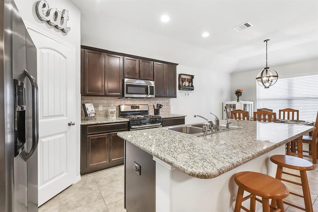 3010 Dripping Springs Court Katy, TX 77494 - Photo 6 of 22 a kitchen with stainless steel appliances granite countertop a sink refrigerator and cabinets