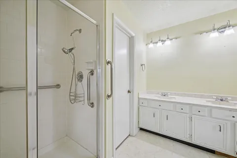 a bathroom with a shower and a sink