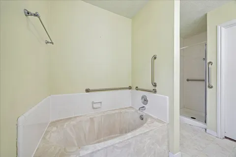 a bathroom with a tub and a shower