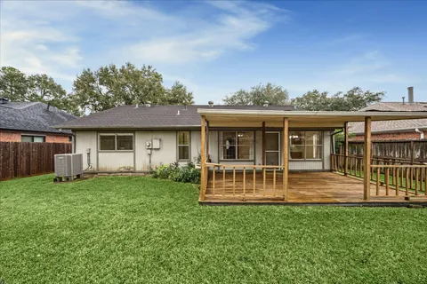 a view of a house with a yard and porch