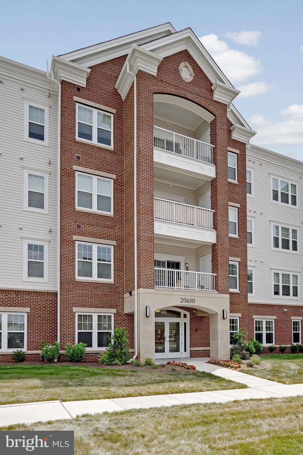 20650 Hope Spring Terrace, Unit 103 Ashburn, VA 20147 - Photo 2 of 30 a view of building with a lot of windows