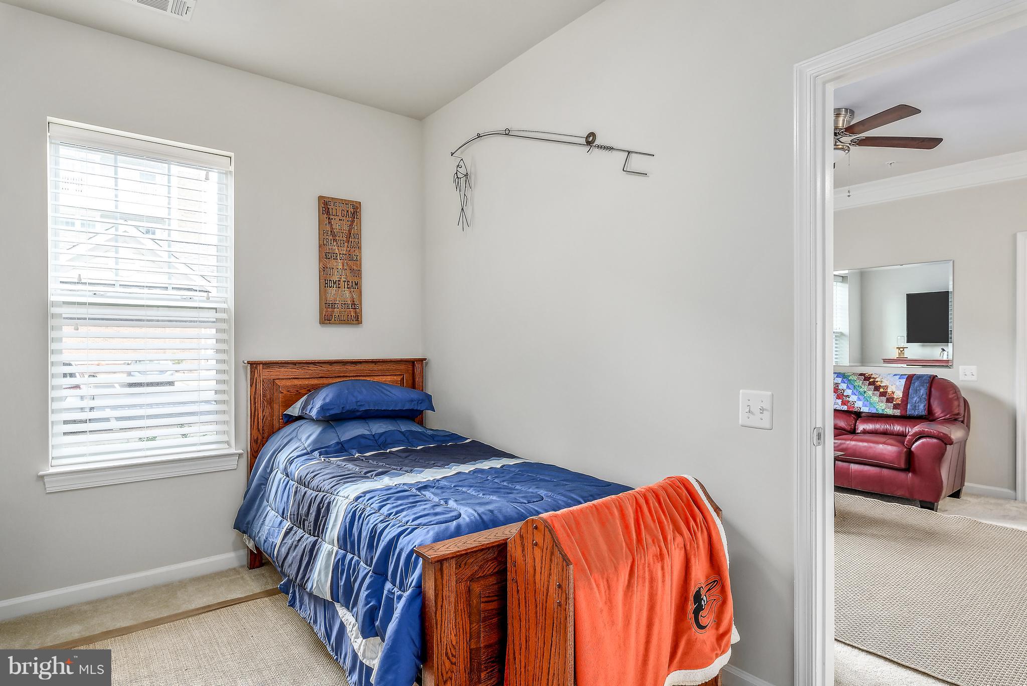 20650 Hope Spring Terrace, Unit 103 Ashburn, VA 20147 - Photo 17 of 30 a bedroom with a bed and hallway